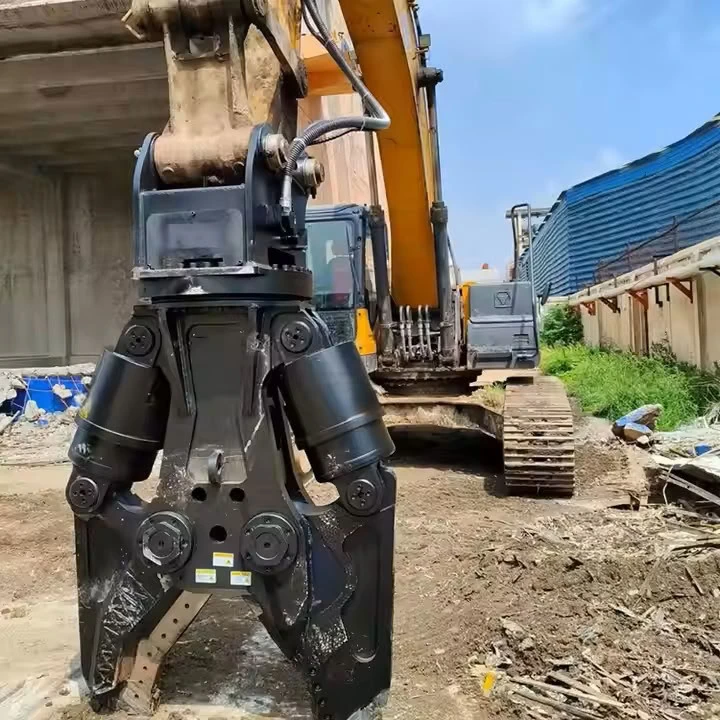 Hydraulic shear connected to an excavator beside a building