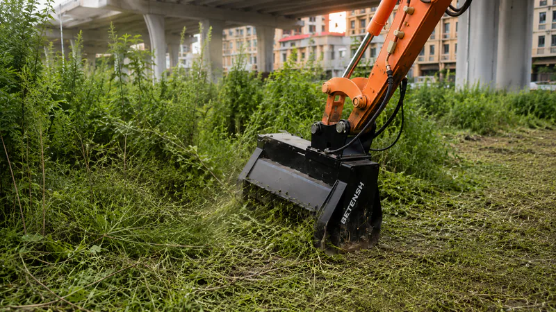 Excavator mulcher clearing vegetation