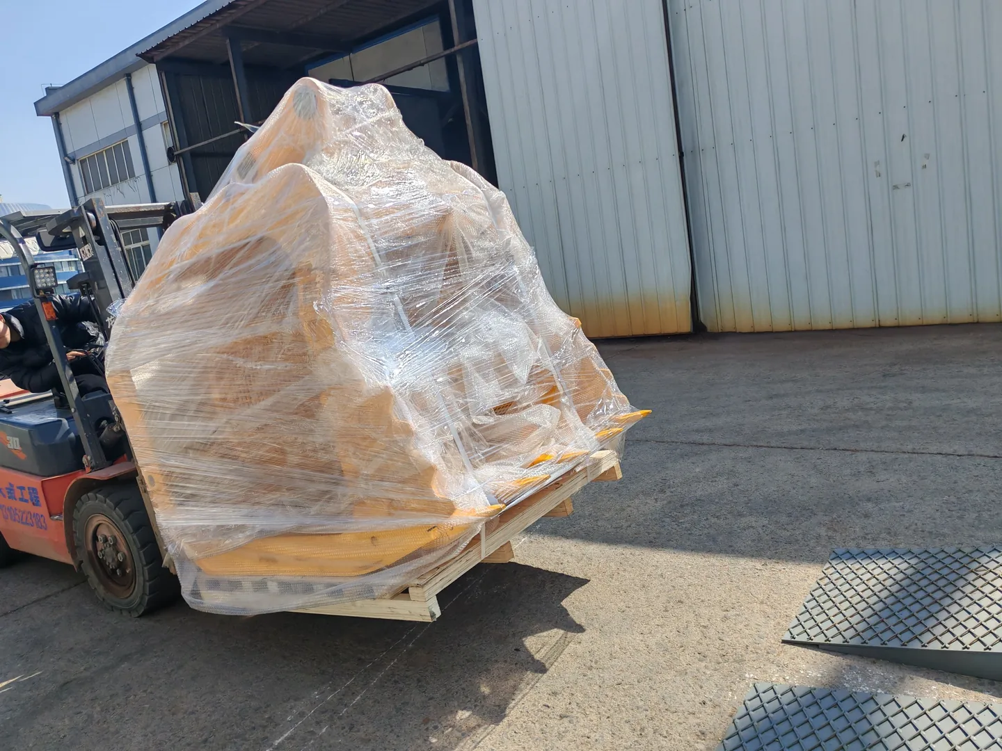 Wrapped Screening Bucket on a pallet being handled by forklift